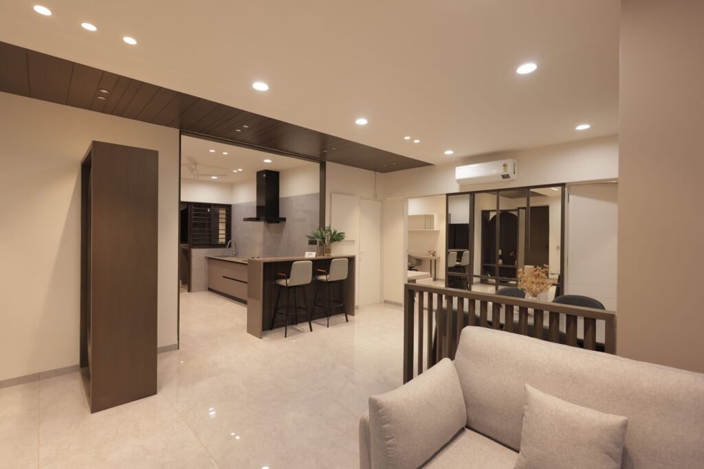 Spacious modern living room with open kitchen, showcasing minimalist design and neutral tones.